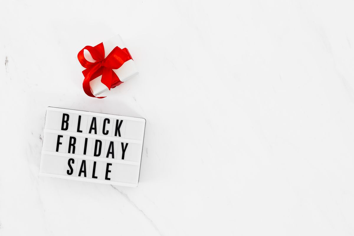 A lightbox sign reading Black Friday Sale beside a small wrapped gift