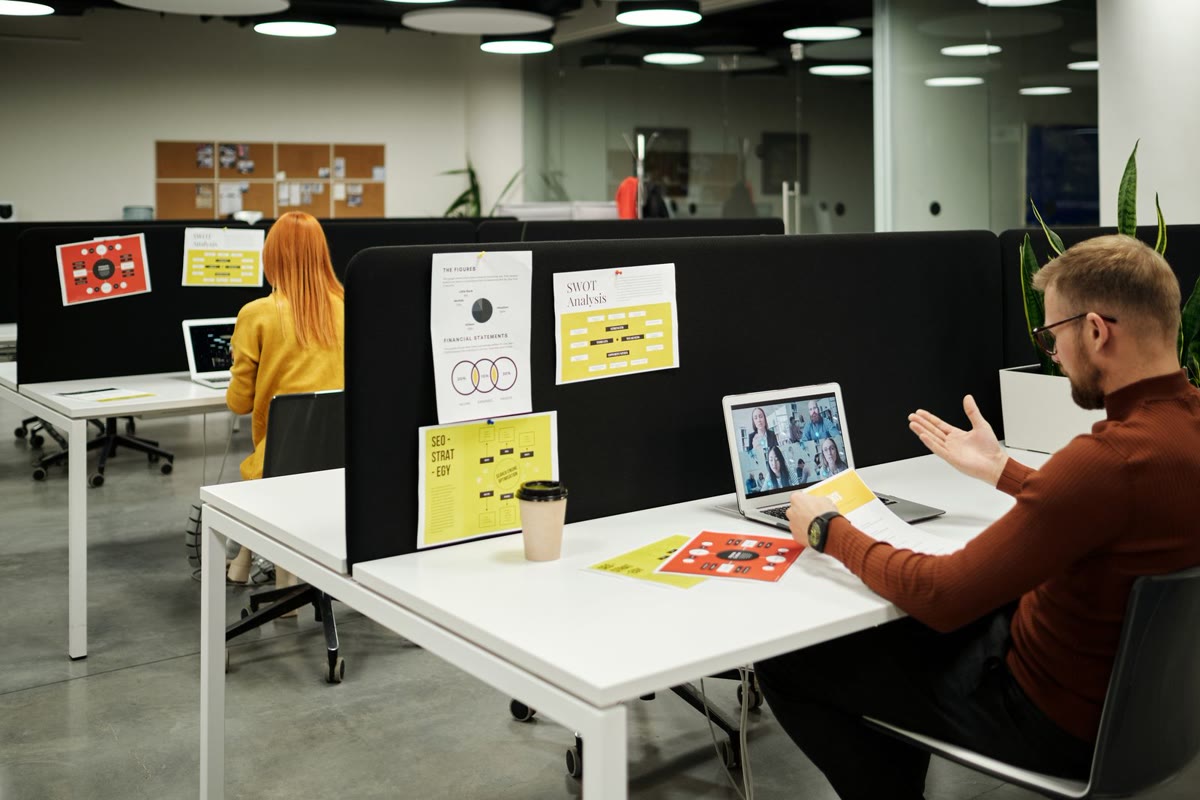 Recruitment consultants working at laptops in an open plan office