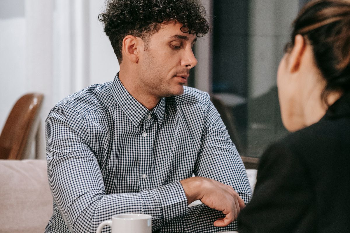 Two people deep in conversation over coffee at a table