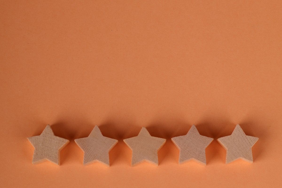 A five star rating display against an orange background