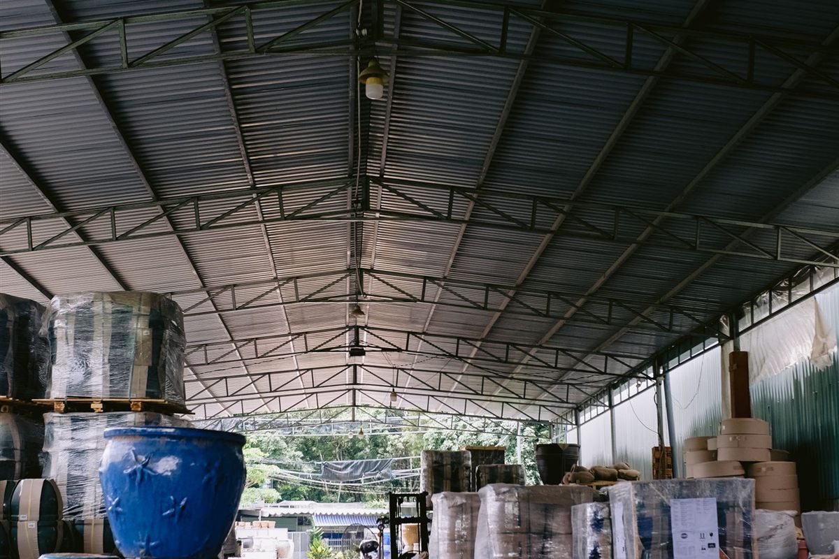 A wholesale stockroom stacked with wrapped pallets and ceramic goods