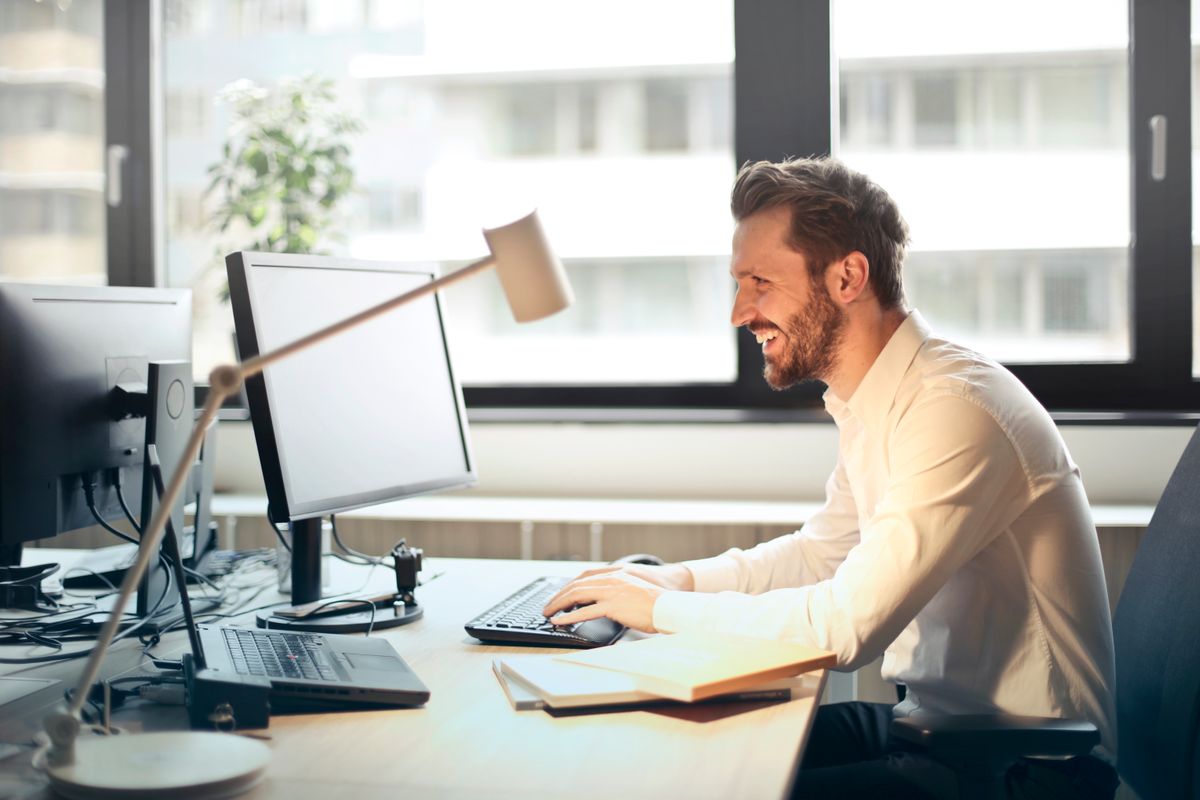 A professional working at a bright, tidy office desk